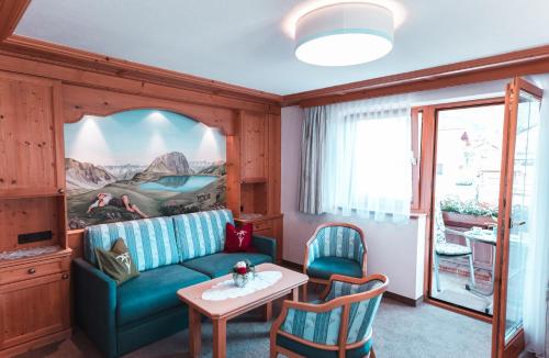 a living room with a couch and a table at Landhaus Marion in Holzgau