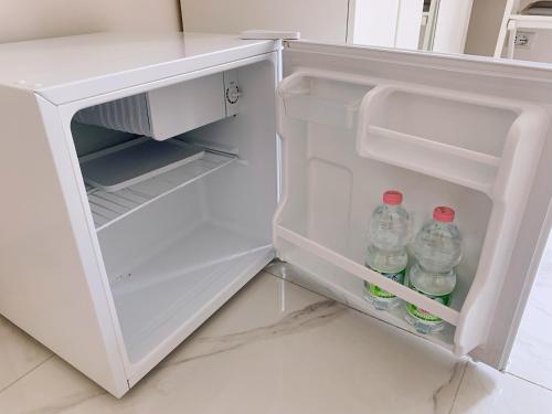 an open refrigerator with two bottles of water in it at Bed & Breakfast Sweet life La spezia Liguria in La Spezia