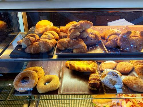 a display case in a bakery filled with lots of pastries at Bed & Breakfast Sweet life La spezia Liguria in La Spezia