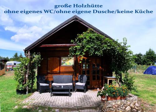 a gazebo with two chairs and a table at Kanucamp Altfriesack in Altfriesack