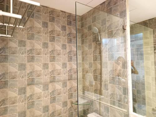 a bathroom with a shower with a glass door at Lovely Stay Grand North Tower Cebu in Cebu City