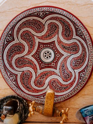 a plate with a design on top of a table at Deep Desert Camp in Merzouga