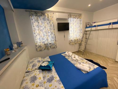 a bedroom with a blue bed and a bunk bed at MarEtna in Giardini Naxos
