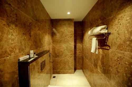 a bathroom with a sink and a shower at Hotel The Spades in Zirakpur