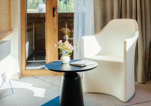 a table and a chair in a room at Best Western Chalet les Saytels in Le Grand-Bornand