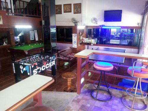 a bar with a pool table and stools in a room at BEN & LEK GUESTHOUSE in Pattaya South