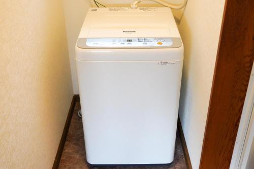 a white washer and dryer in a room at Nikko Cottage Yurt in Nikko