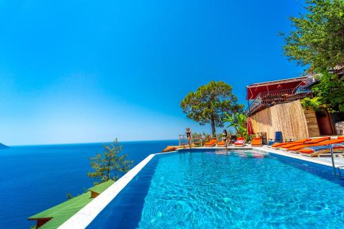 a swimming pool with a view of the ocean at MANZARA BUNGALOW in Fethiye