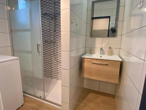 a bathroom with a shower and a sink and a mirror at Apartmán 5FIVE in Prešov