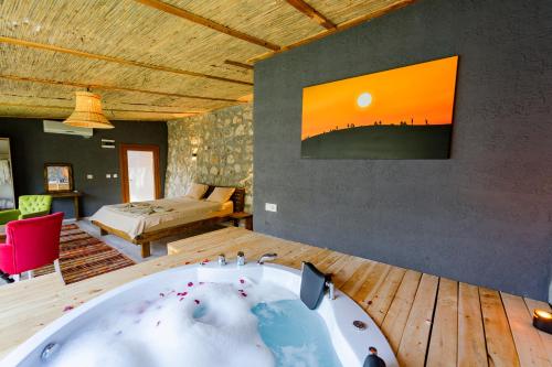 a bathroom with a bath tub in a room at MANZARA BUNGALOW in Fethiye