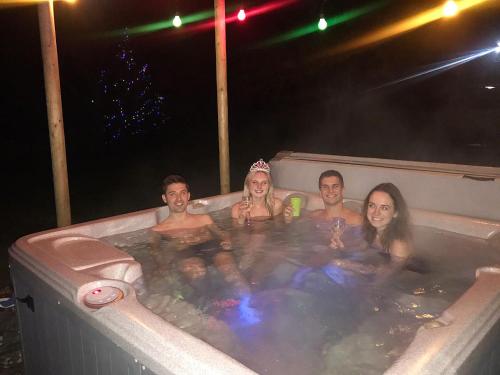 a group of people in a hot tub at night at Canny Brow Barn in Kendal
