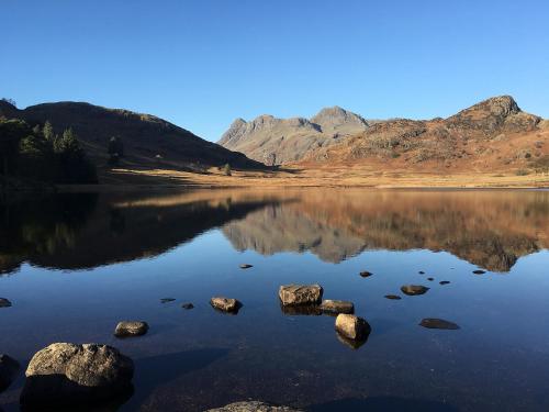 a large body of water with mountains in the background at Canny Brow Barn in Kendal