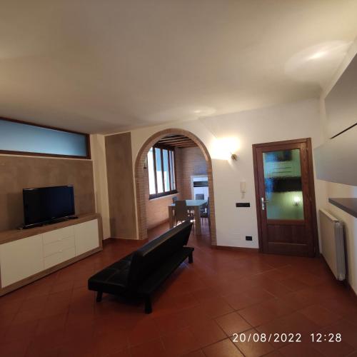 a living room with a couch and a television at M & M Pinzi Suite Apartment in Montepulciano Stazione