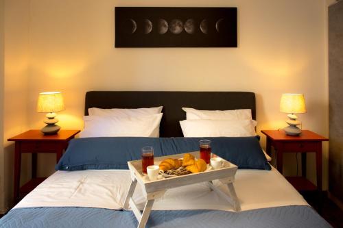 a bedroom with two beds with a tray of food at Ρetipe Penthouse Apartment with spacious Balcony in Heraklion Center in Heraklio