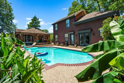 a swimming pool in front of a house at Dallas Oak Lawn Oasis w/ Private Pool, Hot Tub in Dallas