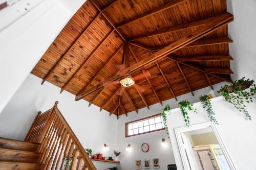 a room with wooden ceilings and a staircase at Dallas Oak Lawn Oasis w/ Private Pool, Hot Tub in Dallas