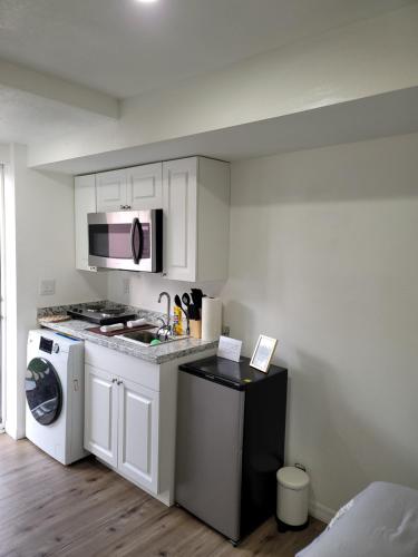 a kitchen with a stove and a microwave at Cozy studio apt in Orlando