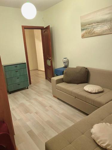 a living room with a couch and a table at Dainiaus Apartamentai in Palanga