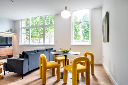 a living room with a couch and a table and chairs at Marygate - Museum Apartment in York