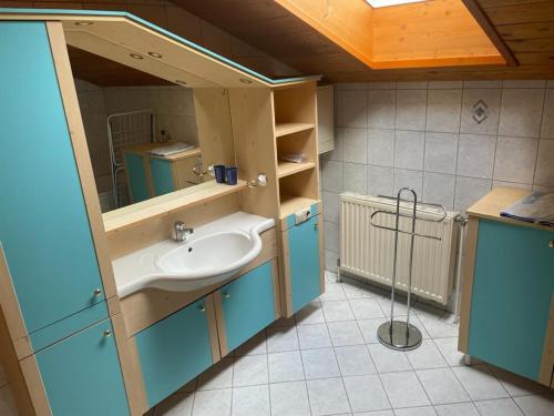 a bathroom with a sink and a mirror at Ferienwohnung ,Hoizmann` in Pinsdorf