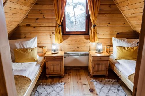 a room with two beds in a log cabin at Magurska Ostoja in Jasło