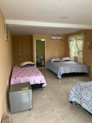 a bedroom with two beds in a room at Posada Miss Portia in Providencia