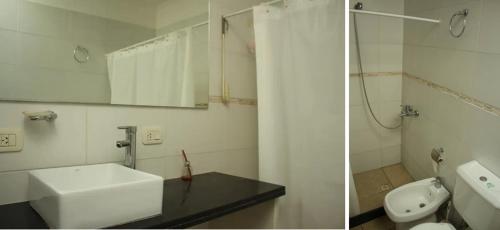 a white bathroom with a sink and a toilet at Habitaciones en casa encantada para viajeros in Gualeguaychú