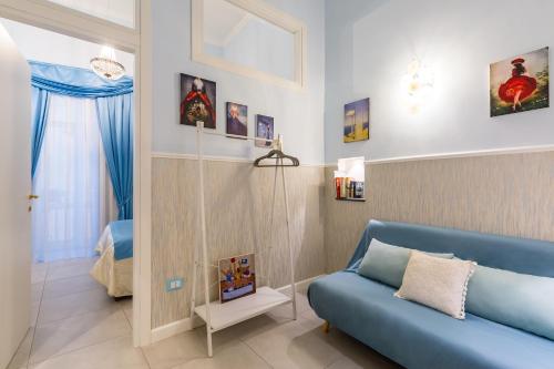 a living room with a blue couch at Casa Parravano in Caserta