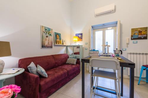 a living room with a red couch and a table at Casa Parravano in Caserta