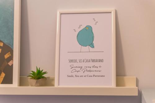 a framed picture of a blue bird on a shelf at Casa Parravano in Caserta