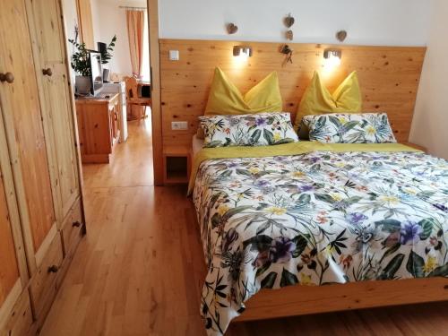 a bedroom with a bed with a floral bedspread at Appartement Seppi in Innsbruck
