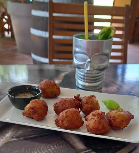 a plate of food with meatballs on a table at BO SOLEY, studio vue mer Les Hauts de Caritan in Sainte-Anne