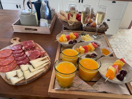 a table topped with plates of food and glasses of wine at Cal Robusto, Apartament in Masía with horses in Siurana
