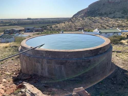 a large pool of water sitting on top of a hill at Sterrenhemel Guest Farm in Upington