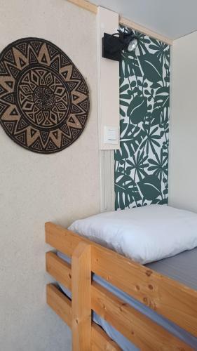a room with a bed and a plate on the wall at Le petit chalet d' Anto-Francè in Levie