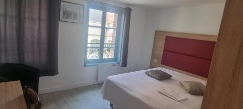 a small bedroom with a bed and a window at Valenciennes appart in Valenciennes