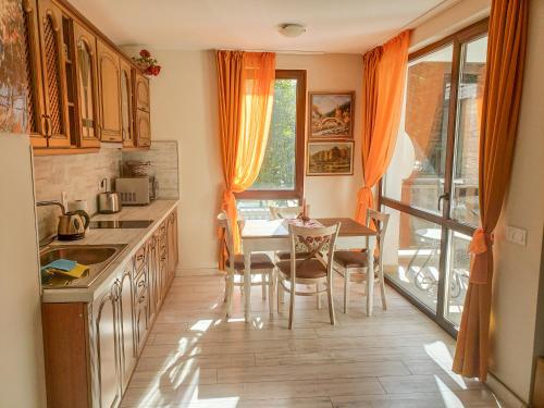 a kitchen with a table and chairs and a dining room at Lovely Borovets Apartment in Borovets