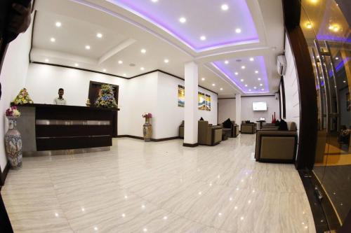 a lobby with a dance floor and purple lighting at Blue Beach Hotel in Wadduwa