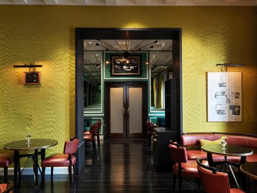 a restaurant with tables and chairs in a room with yellow walls at J.K. Place Roma - The Leading Hotels of the World in Rome