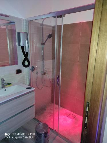 a bathroom with a shower with a pink light at Top Apartment Roma 2 in Rome