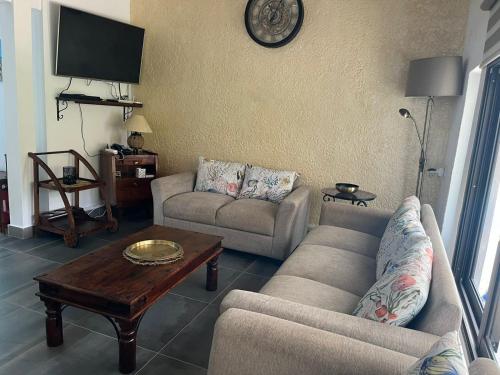 a living room with two couches and a coffee table at Villa Tourelle of Paradise with bigPrivate Pool in Rivière Noire