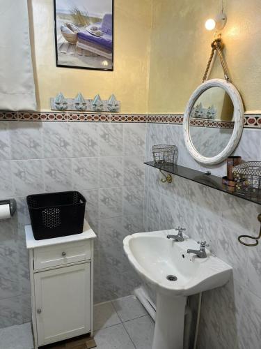 a bathroom with a sink and a mirror at Villa Tourelle of Paradise with bigPrivate Pool in Rivière Noire