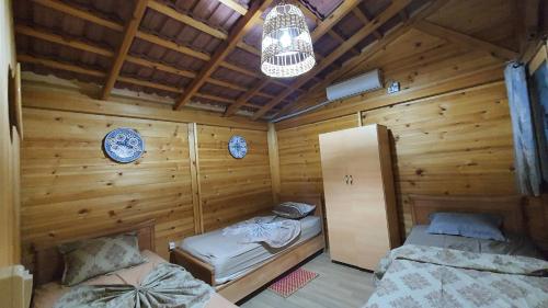 a room with two beds in a wooden cabin at Chalet Jaune Diar Mammoura in Nabeul
