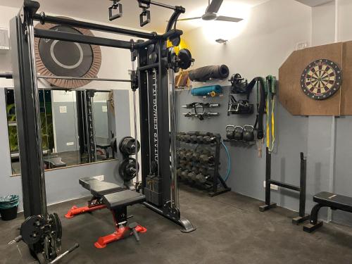 a room with a gym with weights and a dartboard at Casa Da Praia in Candolim