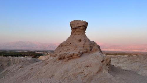 a large pile of white rocks in the desert at The Lowest Place on Earth B&B in Neʼot HaKikar