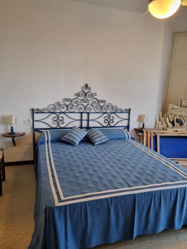 a blue bed with two pillows in a bedroom at Condomino Giuditta in Porto Santa Margherita di Caorle