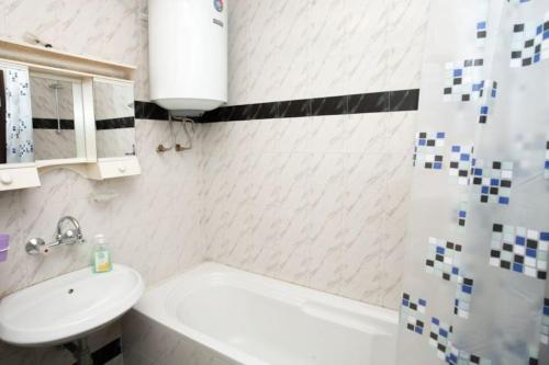 a bathroom with a sink and a toilet and a shower at Beautiful location apartment in Sofia