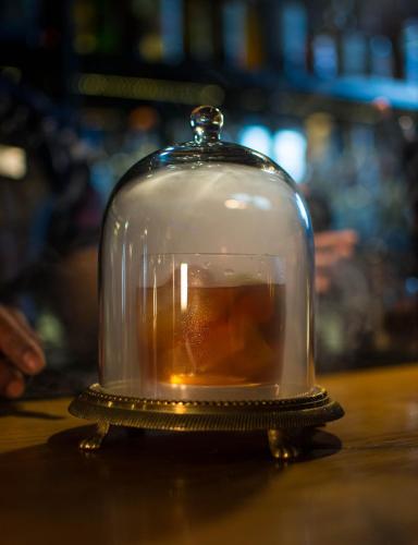 a glass jar with a candle in it on a table at Casa 1810 Hotel Boutique in San Miguel de Allende