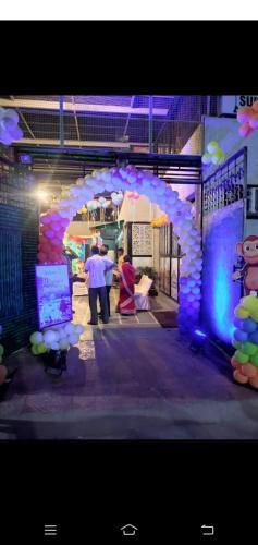 two people standing under an arch with an umbrella at Sukh Sagar Hotel in Jaipur