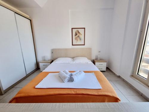 a bedroom with a bed with two towels on it at Sea - View in Himare